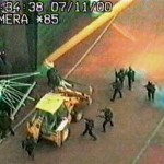 Armed police surround the digger used by the raiders in 2000