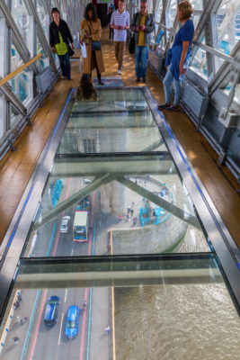 view from high-level walkway of Tower Bridge on the bridge traffic in London, UK