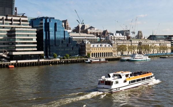 A water taxi transports people along the River Thames in London, England