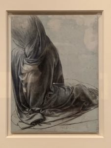 The drapery of a kneeling figure