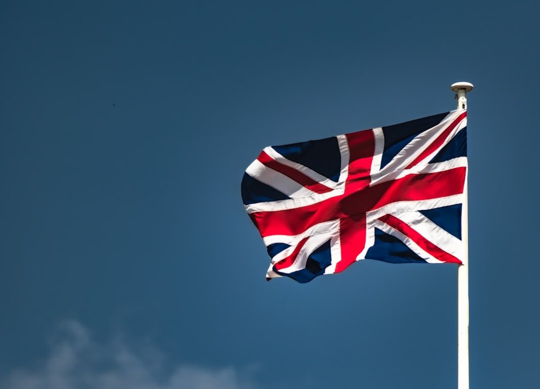 a flag flying in the wind on a clear day